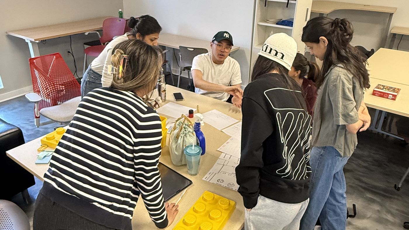 The six-person Canon capstone team working around a table